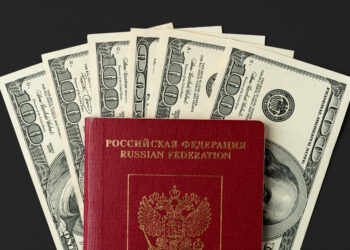 Russian passport with US dollar banknotes inside. High quality photo