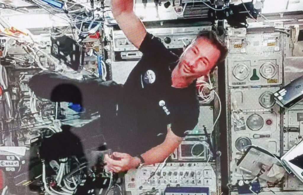 Przebywający na Międzynarodowej Stacji Kosmicznej polski astronauta Sławosz Uznański-Wiśniewski (na ekranie) podczas połączenia wideo Fot. PAP/Marian Zubrzycki