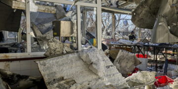 Ukraińscy ratownicy pracują na miejscu ataku na cywilny zakład w Charkowie. Fot. PAP/EPA/SERGEY KOZLOV