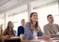 Happy female student and her friends having a class at the university,